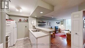 Toronto (Waterfront Communities) condo for rent - A modern kitchen with white appliances and a central island.