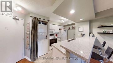 Toronto (Waterfront Communities) condo for rent - A kitchen with a white refrigerator and a counter top.