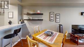Toronto (Waterfront Communities) condo for rent - A dining room with a wooden table and chairs.