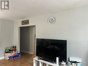 Ajax (Central West) multi-family for rent - A living room with a flat screen TV and a white piano.