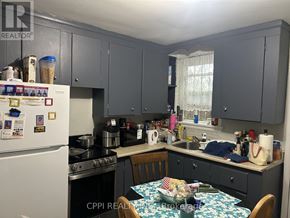 Ajax (Central West) multi-family for rent - A kitchen with a table and chairs in front of it.