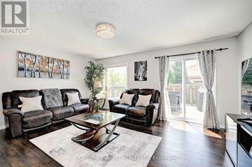 Kitchener townhouse for rent - A living room with a black leather couch and a glass coffee table.