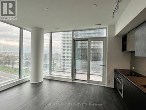 Vaughan (Vaughan Corporate Centre) condo for rent - A spacious kitchen with a view of the cityscape outside the large windows.