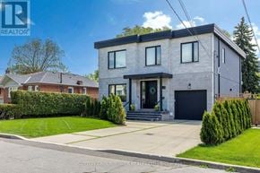 Toronto (Maple Leaf) apartment for rent - A modern two-story house with a grey exterior and a black garage door.