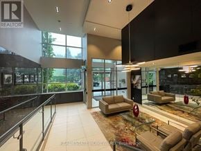 Toronto (Birchcliffe-Cliffside) condo for rent - A real estate office lobby with a glass railing and a red circular object on the floor.