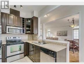 Cobourg townhouse for rent - A kitchen with a stove top oven and a microwave.