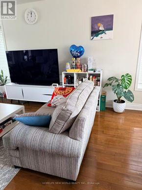 Cobourg townhouse for rent - A living room with a grey couch and a television.