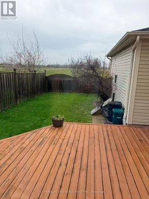 Cobourg townhouse for rent - A wooden deck with a potted plant on it.