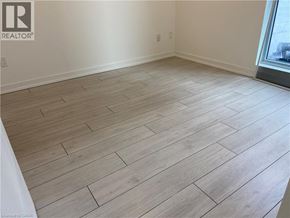 Kitchener condo for rent - A room with wooden flooring and a window.