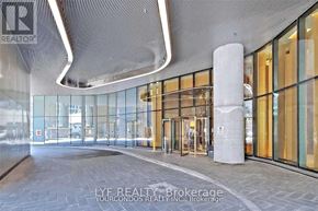 Toronto (Bay Street Corridor) condo for rent - The image shows the entrance to a building with a glass door and a pillar in front.