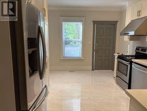 Toronto (South Riverdale) apartment for rent - A kitchen with a refrigerator, oven, and stove top oven.