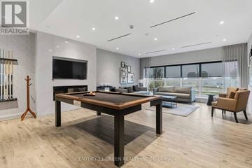 Oakville (Go Glenorchy) condo for rent - A modern living room with a wooden table and chairs.