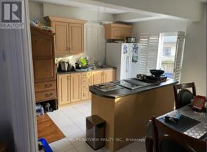 Toronto (Little Portugal) apartment for rent - A kitchen with wooden cabinets and a refrigerator.