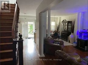 Toronto (Little Portugal) apartment for rent - A living room with a couch, a chair, and a TV.