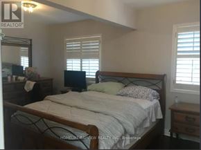 Toronto (Little Portugal) apartment for rent - A bedroom with a bed, nightstand, and window with blinds.