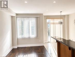 Vaughan (Patterson) apartment for rent - A well-lit, spacious room with a wooden floor and a bar area.