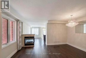 Vaughan (Patterson) apartment for rent - A spacious living room with a fireplace and a chandelier.