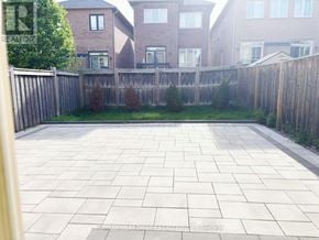 Vaughan (Patterson) apartment for rent - A backyard with a paved patio and a wooden fence.