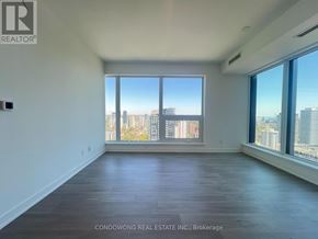 Toronto (Bay Street Corridor) condo for rent - Empty room with a view of the cityscape outside the window.