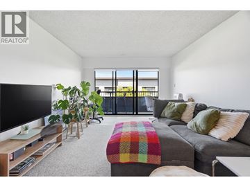Vancouver apartment for rent - A living room with a grey couch and a flat screen TV.