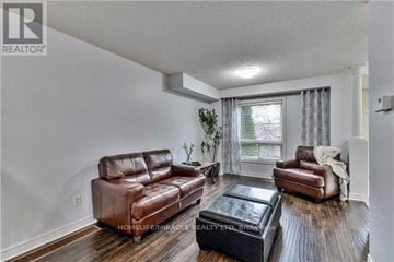 Brampton (Fletcher's Meadow) apartment for rent - A living room with a brown leather couch and ottoman.