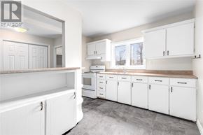 St. John's apartment for rent - A kitchen with white cabinets and a grey floor.