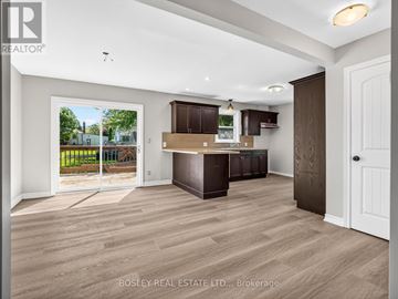 St. Catharines (Bunting/Linwell) apartment for rent - A spacious kitchen with dark brown cabinets and a white door.