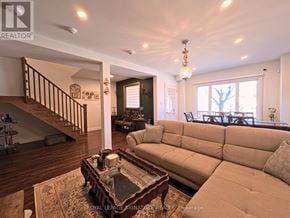 Toronto (O'connor-Parkview) apartment for rent - A living room with a couch, coffee table, and staircase.