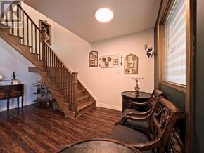 Toronto (O'connor-Parkview) apartment for rent - A wooden staircase with a table and chairs in front of it.
