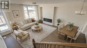 Toronto (Downsview-Roding-Cfb) townhouse for rent - A well-lit living room with a couch, chairs, and a coffee table.