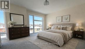 Toronto (Downsview-Roding-Cfb) townhouse for rent - A bedroom with a large bed, a dresser, and a window overlooking a snowy landscape.