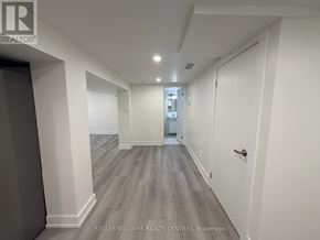Toronto (Thistletown-Beaumonde Heights) apartment for rent - A long hallway with doors on both sides and a light on the wall.