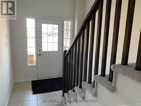 Brant (Paris) apartment for rent - A hallway with a white door and a carpeted staircase.