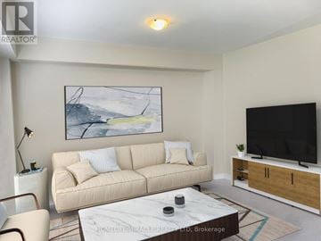 Brant (Paris) apartment for rent - A living room with a beige couch, a painting on the wall, a flat screen TV, and a coffee table.