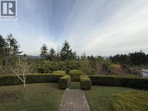 West Vancouver apartment for rent - A well-manicured garden with a pathway leading to a hedge.