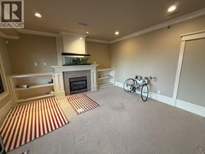 West Vancouver apartment for rent - A living room with a fireplace and a bicycle.