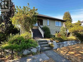 North Vancouver apartment for rent - A house with a stone wall and a stone pathway leading to the front door.