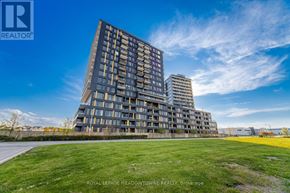 Burlington (Alton) condo for rent - A modern multi-story building with a grassy area in front.