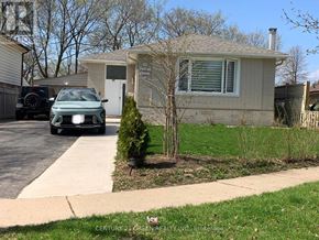 Brampton (Northwood Park) apartment for rent - A green car is parked in front of a house.