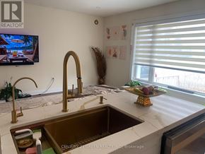 Brampton (Northwood Park) apartment for rent - A kitchen with a sink and a TV mounted on the wall.