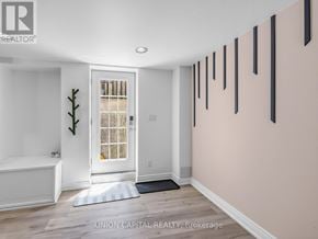 Mississauga (Hurontario) apartment for rent - A white bathtub sits in a bathroom with a window and a door.