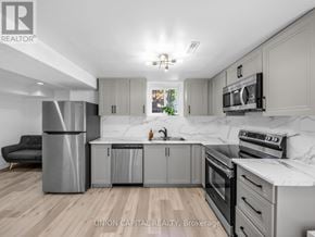 Mississauga (Hurontario) apartment for rent - A modern kitchen with wooden floors and marble countertops.