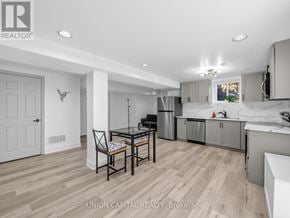 Mississauga (Hurontario) apartment for rent - A kitchen with a table and chairs in the middle of the room.