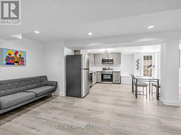 Mississauga (Hurontario) apartment for rent - A living room with a grey couch and a painting on the wall.