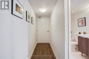 Toronto (Flemingdon Park) condo for rent - A hallway with a toilet and sink on the right side.