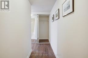 Toronto (Flemingdon Park) condo for rent - A hallway with a white door and two pictures on the wall.