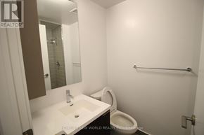 Toronto (Kensington-Chinatown) condo for rent - A white bathroom with a sink, toilet and mirror.
