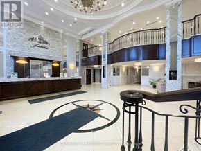 Markham (Unionville) condo for rent - A large, well-lit foyer with a staircase and a reception desk.