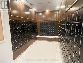 Markham (Unionville) condo for rent - A room full of black mailboxes on a wall.