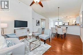 Burlington (Palmer) condo for rent - A living room with a grey couch and a glass coffee table.